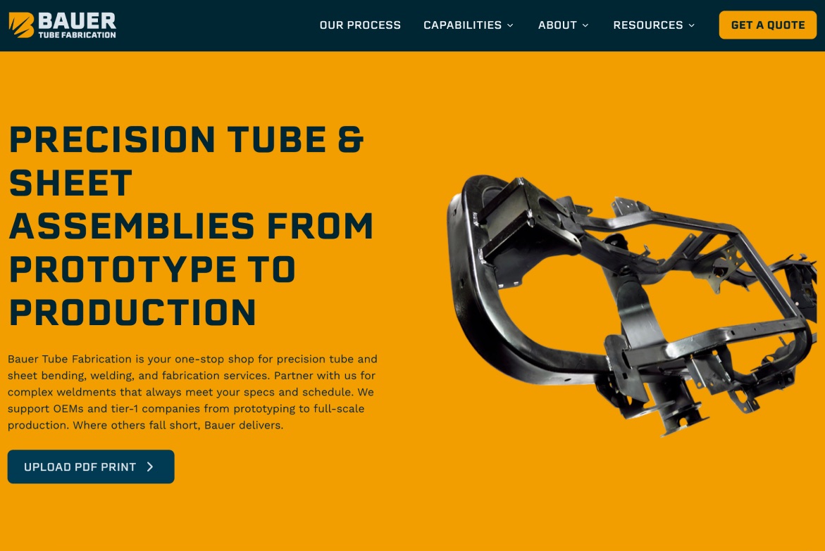 The rebuilt Bauer Tube Fabrication homepage. The headline reads “Precision tube & sheet assemblies from prototype to production,” with a paragraph naming the services and the OEM and tier-1 customers they serve, next to a photo of a welded tube assembly.